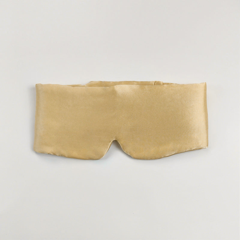 Silk eye mask with ear protection shown from the side, highlighting padded ear covers