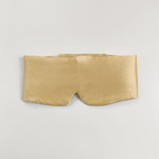 Silk eye mask with ear protection shown from the side, highlighting padded ear covers