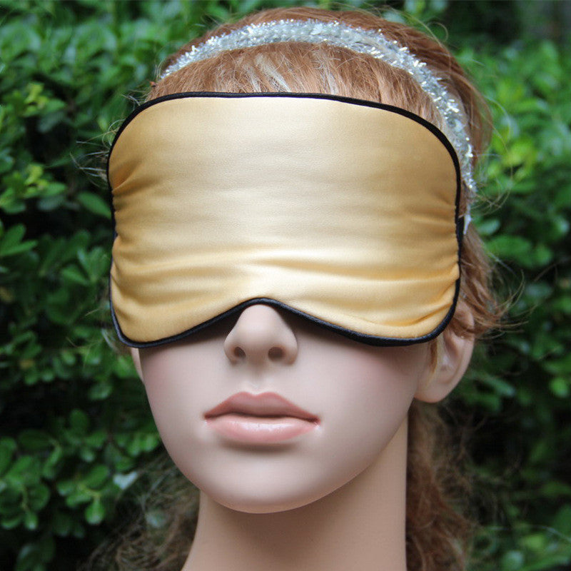 Mulberry silk sleep mask shown with adjustable strap, close-up view