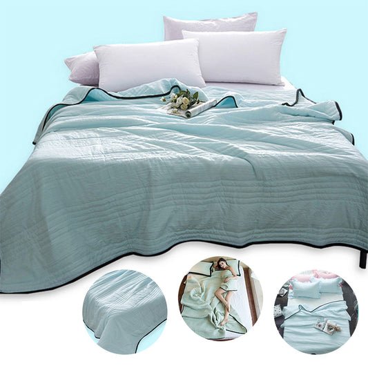 Cooling summer blanket in army green, folded on a bed