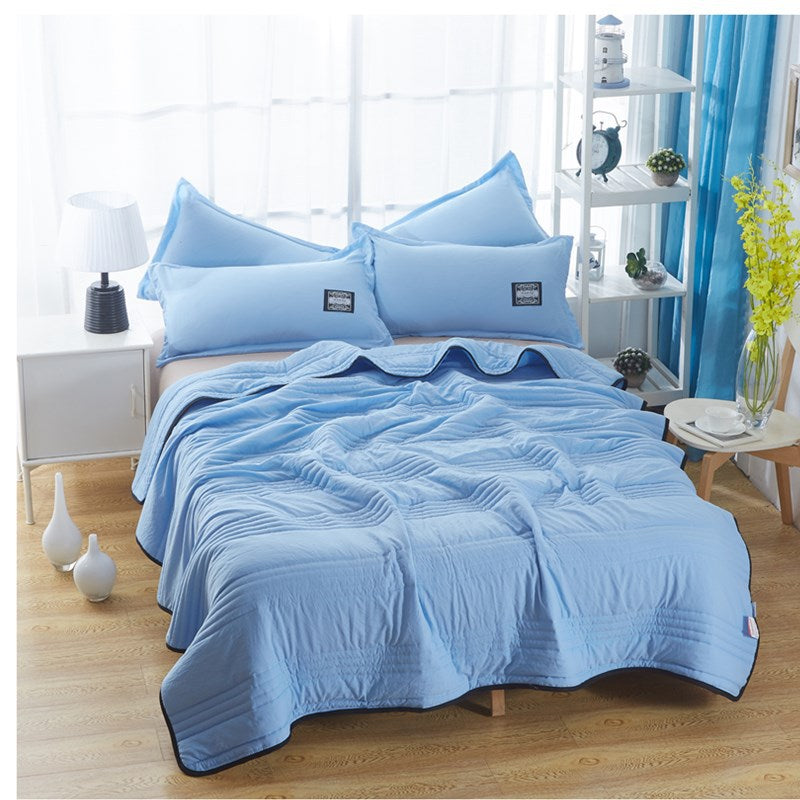 Cooling summer blanket draped over a bed for a cool night's sleep