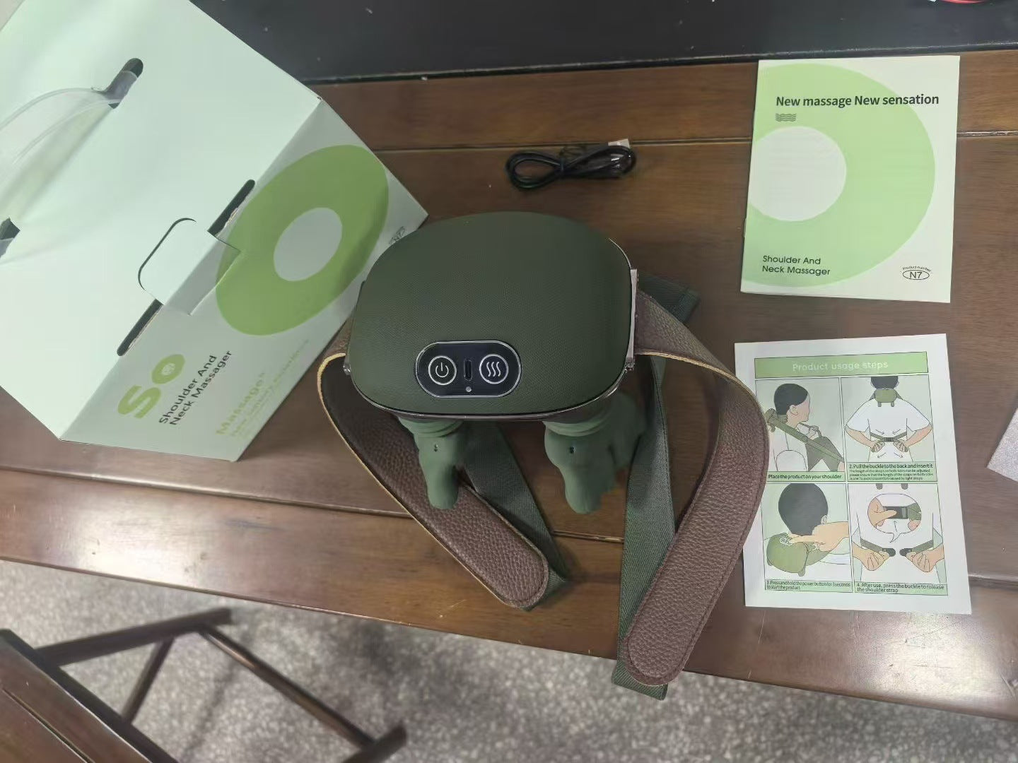 Neck and shoulder massager with adjustable strap for hands-free wear